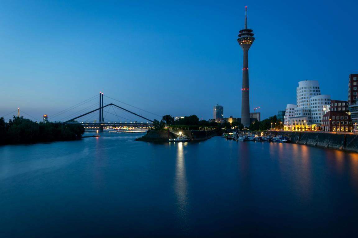Escort Dusseldorf - Media Harbor: Gehry Buildings by the River at Blue Hour Escort Dusseldorf - Media Harbor: Gehry Buildings by the River at Blue Hour